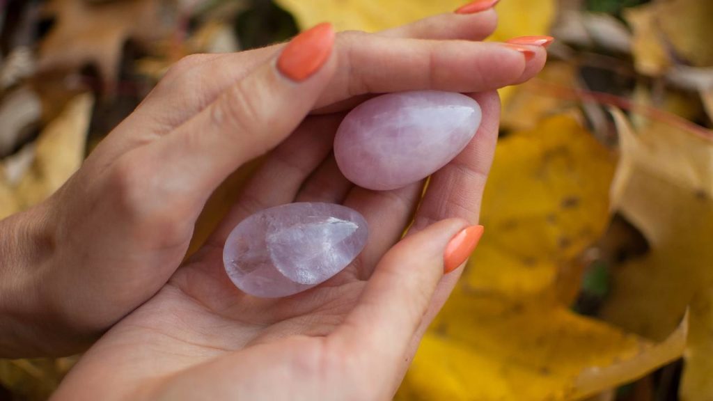 Holding two polished rose quartz stones