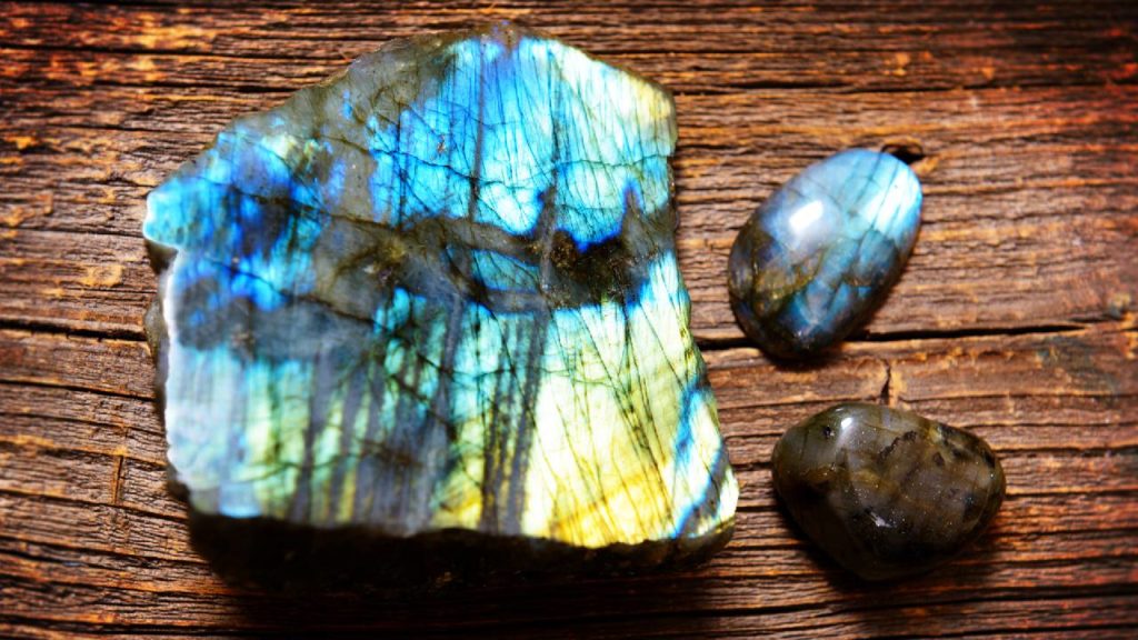 Labradorite stones on wooden background