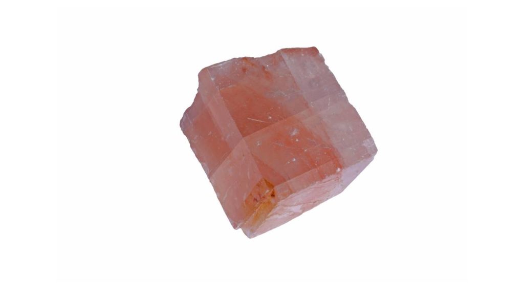 Pink calcite stone on white background
