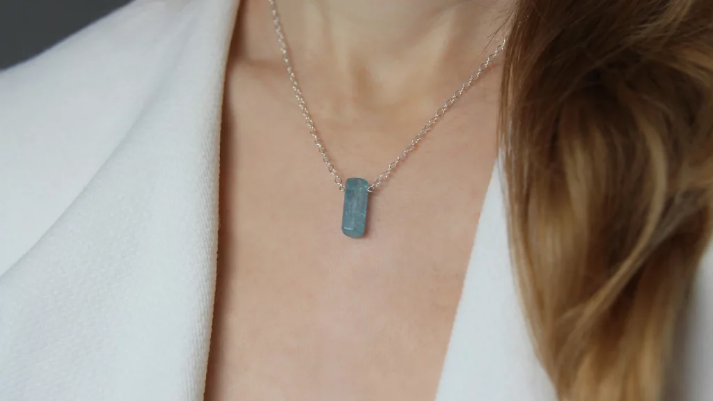 Woman wearing aquamarine necklace