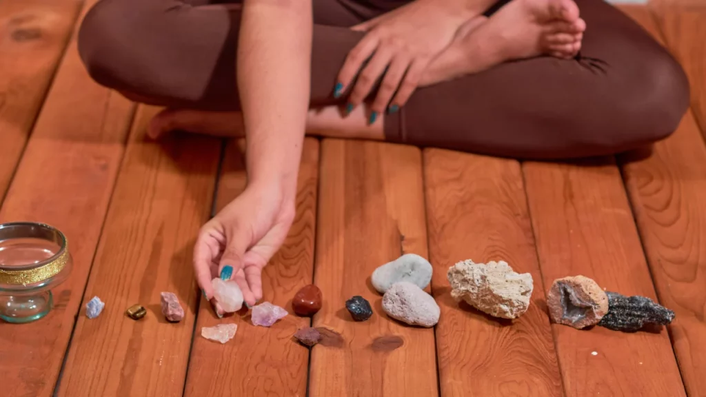 Woman lining up crystals on wooden floor