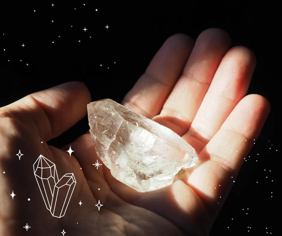 Hand holding clear quartz crystal